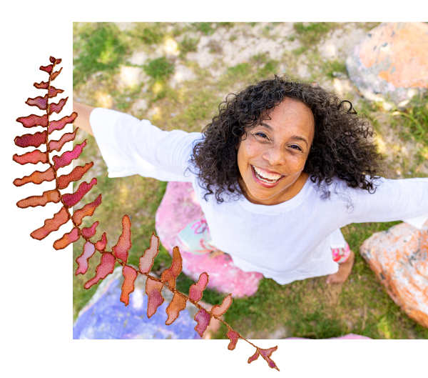 Debbie sun smiling up at the camera with arms outstretched in joy with coral fern watercolor