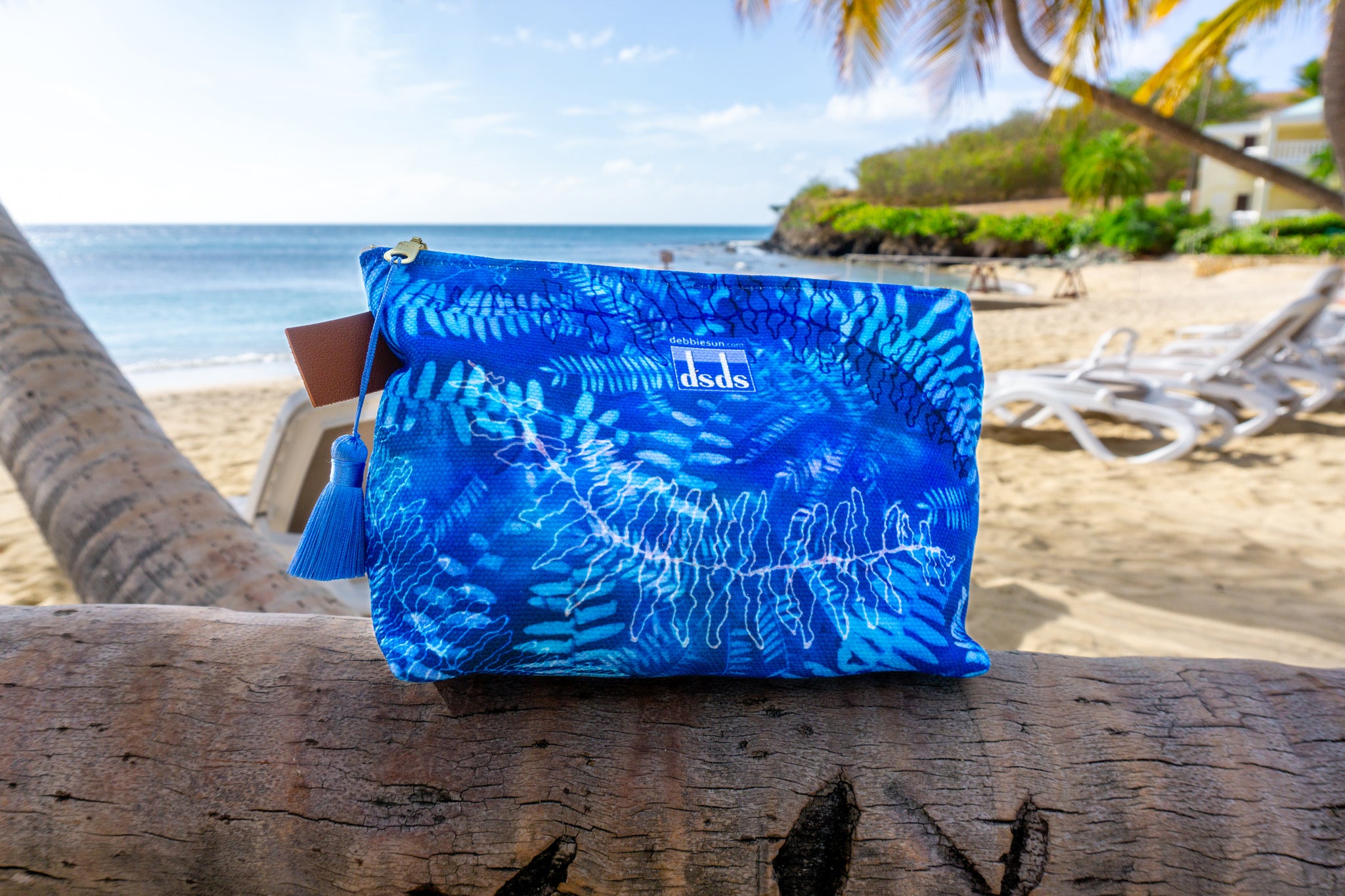 Blue fern patterned zipper pouch on the beach